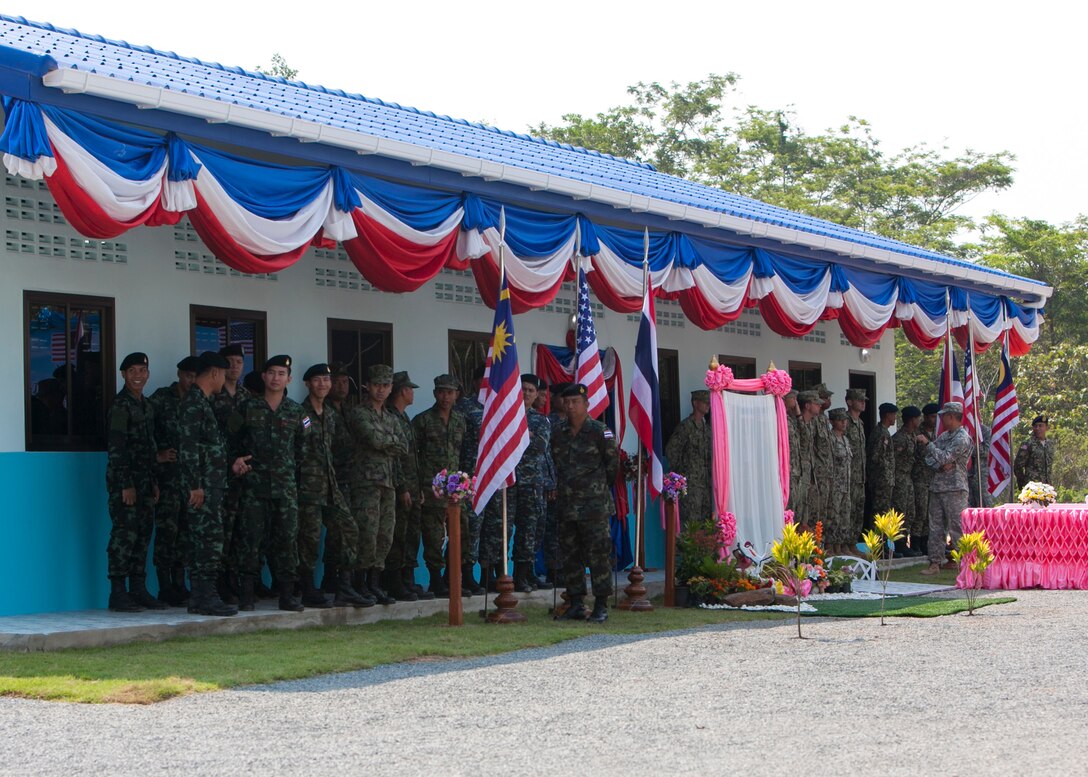 Royal Thai Armed Forces, U.S. Navy and Malaysian Armed Forces service members wait for the start of the dedication ceremony Feb. 18 at Ban Sa Yai, Trat, Thailand. The construction at Ban Sa Yai was one of six humanitarian civic action sites in which the Thai, U.S. and partner nation’s militaries will worked together on civic programs during Cobra Gold 2016. Cobra Gold, in its 35th iteration, demonstrates the commitment of the Kingdom of Thailand and the U.S. to our long-standing alliance and regional partnership toward advancing prosperity and security in the Indo-Asia Pacific region.  (U.S. Marine Corps photo by SSgt. Jose O. Nava/Released)