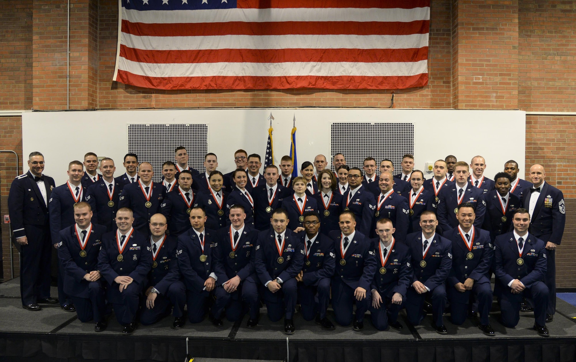 Col. Stephen Kravitsky, 90th Missile Wing commander, and Chief Master Sgt. Samuel Couch, 90th Missile Wing command chief, pose for a photograph with the graduating ALS class 16-C members in the Fall Hall Community Center Feb. 17, 2016. (U.S. Air Force photo by Senior Airman Jason Wiese)