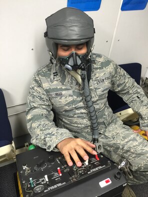 Capt Elliot Reed is gang-loading his oxygen regulator which means all three switches up to allow an increase pressure of oxygen to flow through the mask. This method is used when an aircrew member receives their hypoxia symptoms, goes through a decompression, or is involved in any type of inflight emergency.

