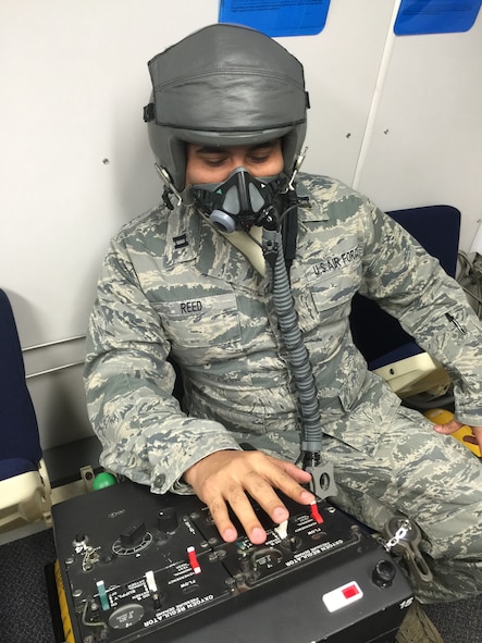 Capt Elliot Reed is gang-loading his oxygen regulator which means all three switches up to allow an increase pressure of oxygen to flow through the mask. This method is used when an aircrew member receives their hypoxia symptoms, goes through a decompression, or is involved in any type of inflight emergency.

