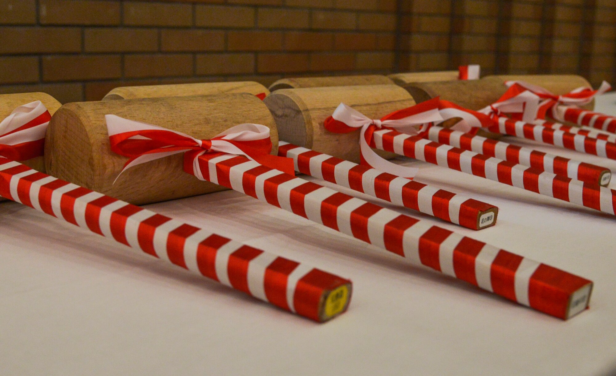 Wooden mallets lay on a table at the Japan Joint Staff 10th anniversary ceremony at Hotel Grand Hill, Ichigaya, Japan, Feb. 17, 2016. Members from the U.S. military and JJS used the mallets to break sake barrels during the ceremony. (U.S. Air Force photo by Senior Airman David Owsianka/Released)