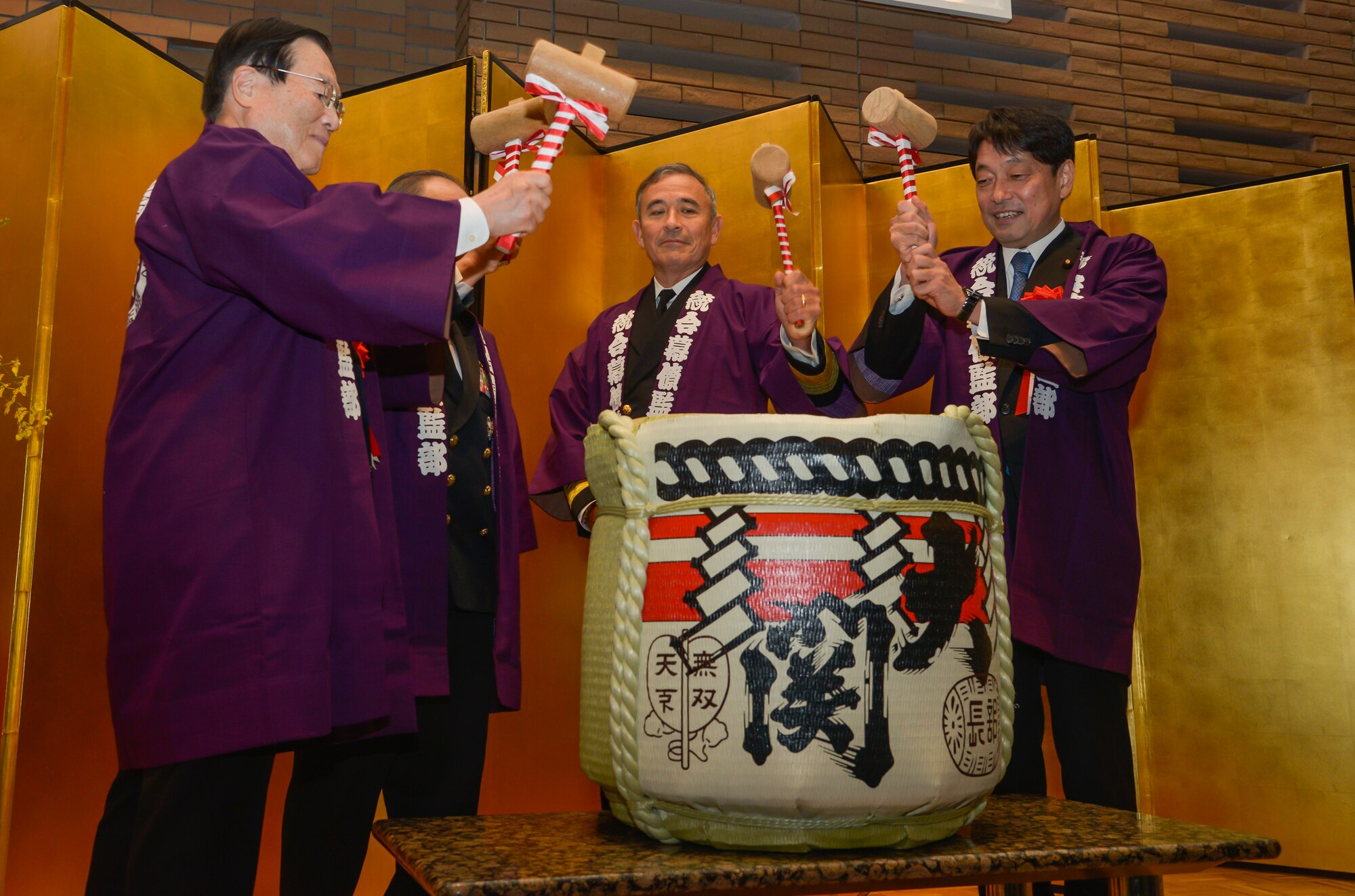U.S. Pacific Command Commander Adm. Harry B. Harris Jr., middle, prepares to hit a sake barrel with Japan Joint Staff members at the JJS 10th anniversary ceremony at Hotel Grand Hill, Ichigaya, Japan, Feb. 17, 2016. This event helped strengthened the bilateral relationship between the U.S. and Japan. (U.S. Air Force photo by Senior Airman David Owsianka/Released)