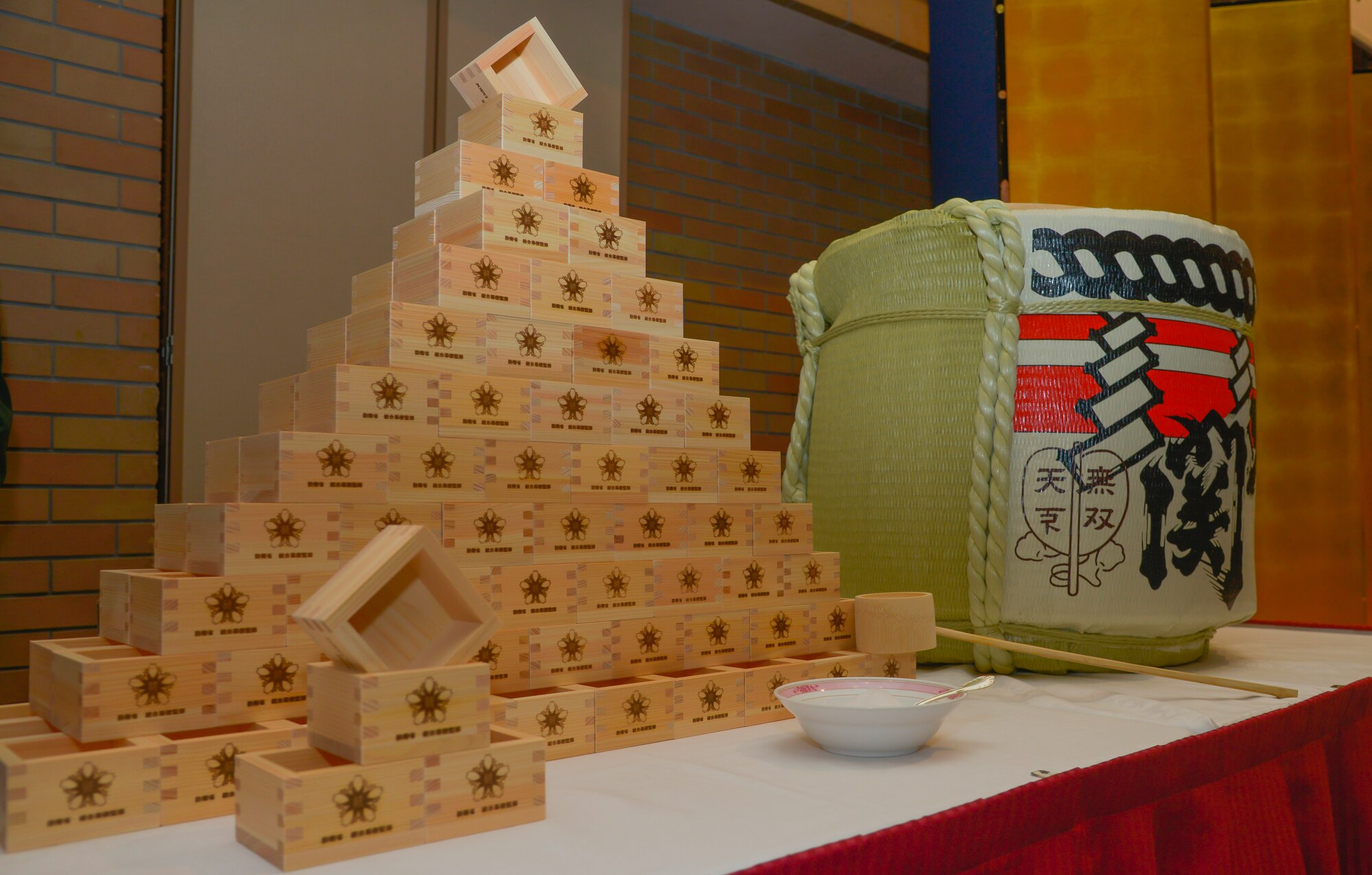 Wooden sake cups and a sake barrel sit on a table during the Japan Joint Staff 10th anniversary ceremony at Hotel Grand Hill, Ichigaya, Japan, Feb. 17, 2016. The event consisted of opening remarks from senior U.S. and Japanese military leadership, breaking sake barrels and discussions between military personnel to strengthen bilateral relationships. (U.S. Air Force photo by Senior Airman David Owsianka/Released)