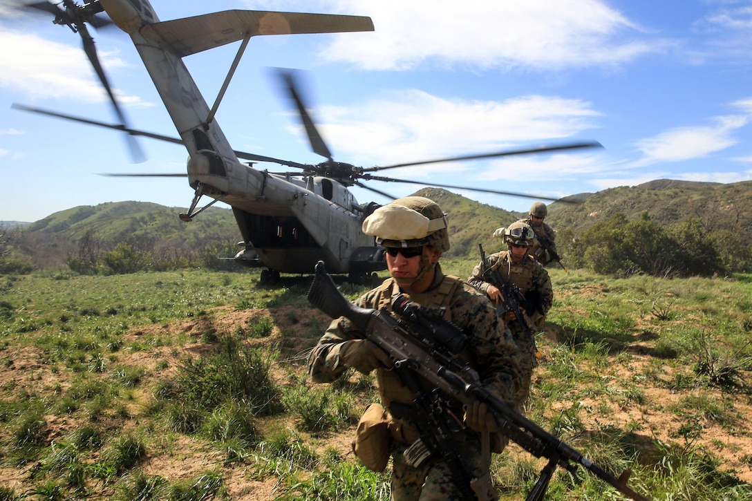 Marines disembark from a CH-53E Super Stallion helicopter to retrieve a simulated injured pilot during a training exercise on Camp Pendleton, Calif., Feb. 10, 2016. The Marines are assigned to the 2nd Battalion, 4th Marine Regiment. Marine Corps photo by Lance Cpl. Devan K. Gowans