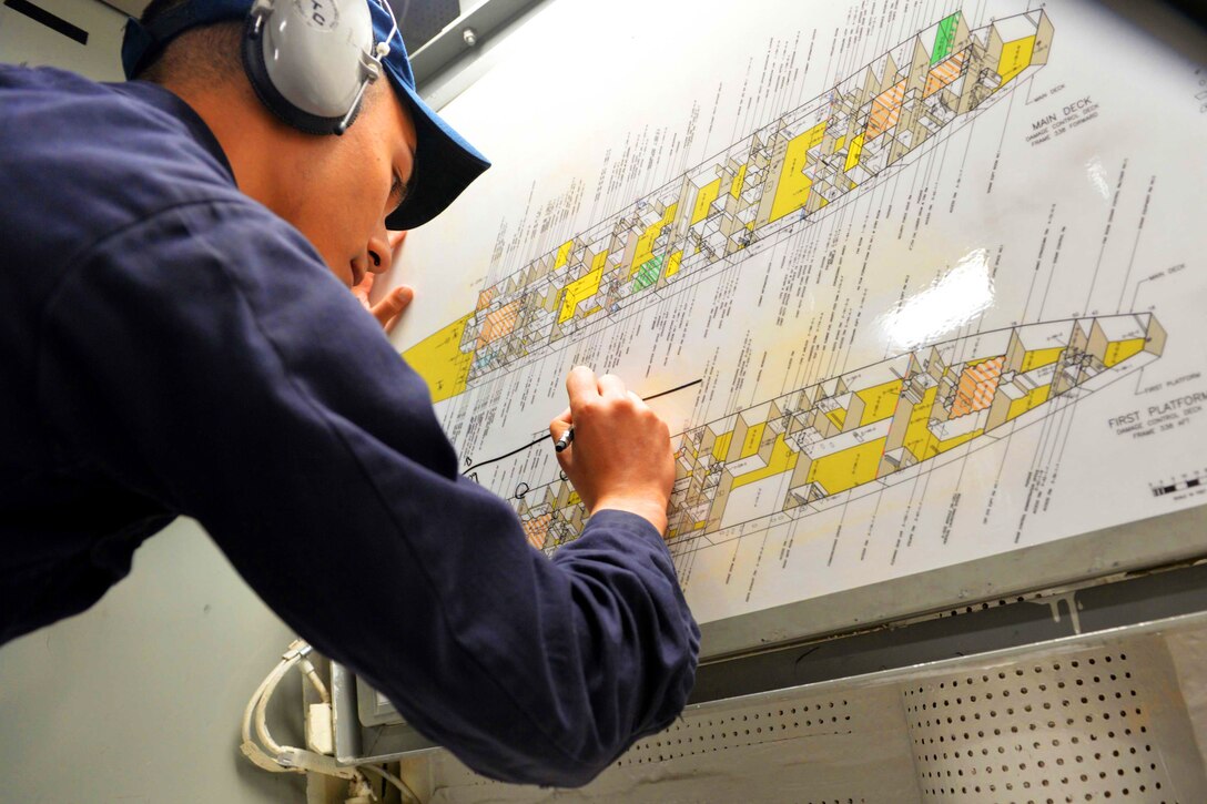 Navy Ensign Nicholas Tsusaki plots damage control points during a simulated fire drill on the USS Ross in the Mediterranean Sea, Feb. 17, 2016. The Ross is conducting a routine patrol to support U.S. national security interests in Europe. Navy photo by Petty Officer 2nd Class Justin Stumberg