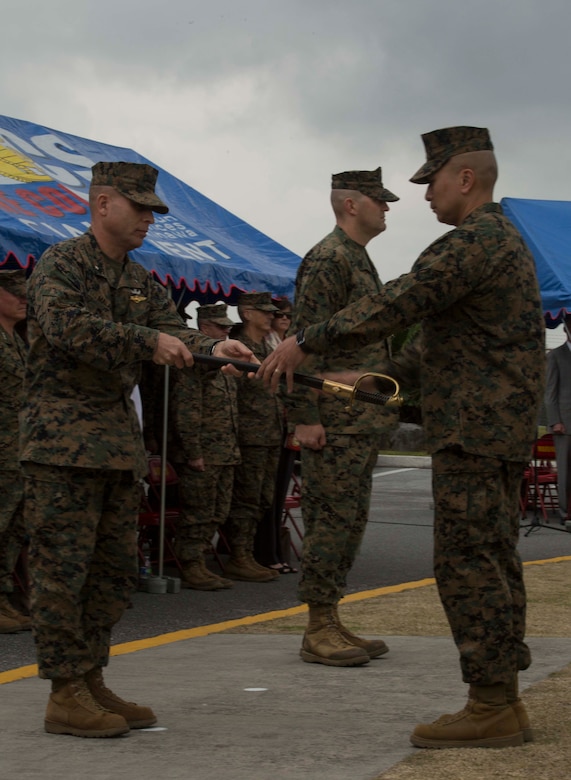 Sgt. Maj. Peter A. Siaw, right, accepts the non-commissioned officer’s sword from Brig. Gen. Joaquin F. Malavet during a relief and appointment ceremony Feb. 19 on Camp Foster, Okinawa, Japan. The passing of the NCO sword signifies the transfer of trust from one sergeant major to another. Siaw relieved Sgt. Maj. R. Kevin Williamson as sergeant major of MCIPAC. Malavet is the commanding general of Marine Corps Installations Pacific-Marine Corps Base Camp Butler, Japan. Siaw is the newly appointed sergeant major of MCIPAC. (U.S. Marine Corps Photo by Cpl. Brittany A. James/ Released)