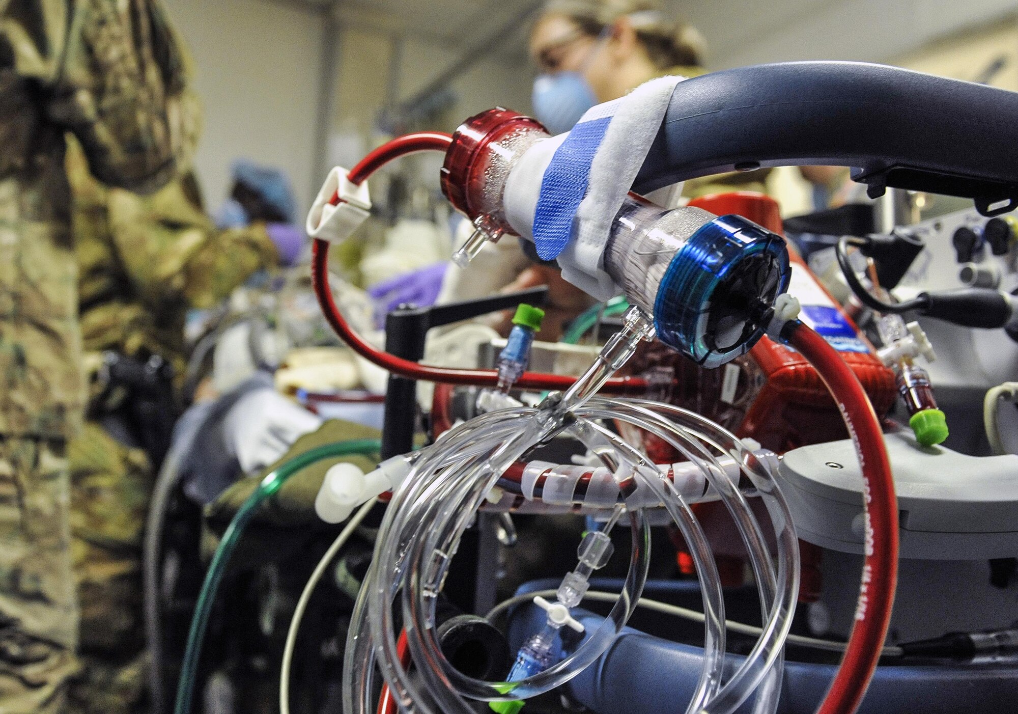 A 455th Expeditionary Medical Group team combines efforts with the Extracorporeal Membrane Oxygenation team to save the life of a NATO ally at the Craig Joint-Theater Hospital at Bagram Air Field, Afghanistan, on Feb. 18, 2016. The ECMO team, dispatched from San Antonio Military Medical Center, uses technology that bypasses the lungs and infuses the blood directly with oxygen, while removing the harmful carbon dioxide from the blood stream. The patient was airlifted to Landstuhl Regional Medical Center, Germany, where he will receive 7 to 14 days of additional ECMO treatment. (U.S. Air Force photo by Tech. Sgt. Nicholas Rau)