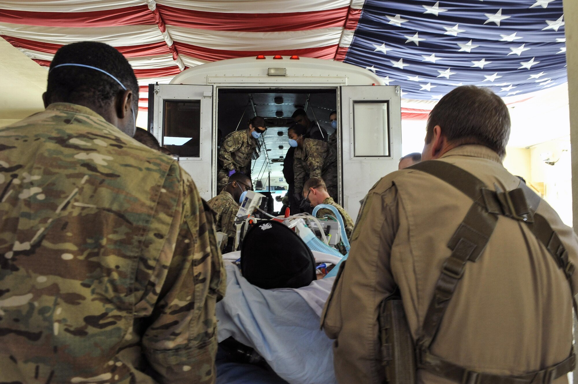 A 455th Expeditionary Medical Group team combines efforts with the Extracorporeal Membrane Oxygenation team to save the life of a NATO ally at the Craig Joint-Theater Hospital at Bagram Air Field, Afghanistan, on Feb. 18, 2016. The ECMO team, dispatched from San Antonio Military Medical Center, uses technology that bypasses the lungs and infuses the blood directly with oxygen, while removing the harmful carbon dioxide from the blood stream. The patient was airlifted to Landstuhl Regional Medical Center, Germany, where he will receive 7 to 14 days of additional ECMO treatment. (U.S. Air Force photo by Tech. Sgt. Nicholas Rau)
