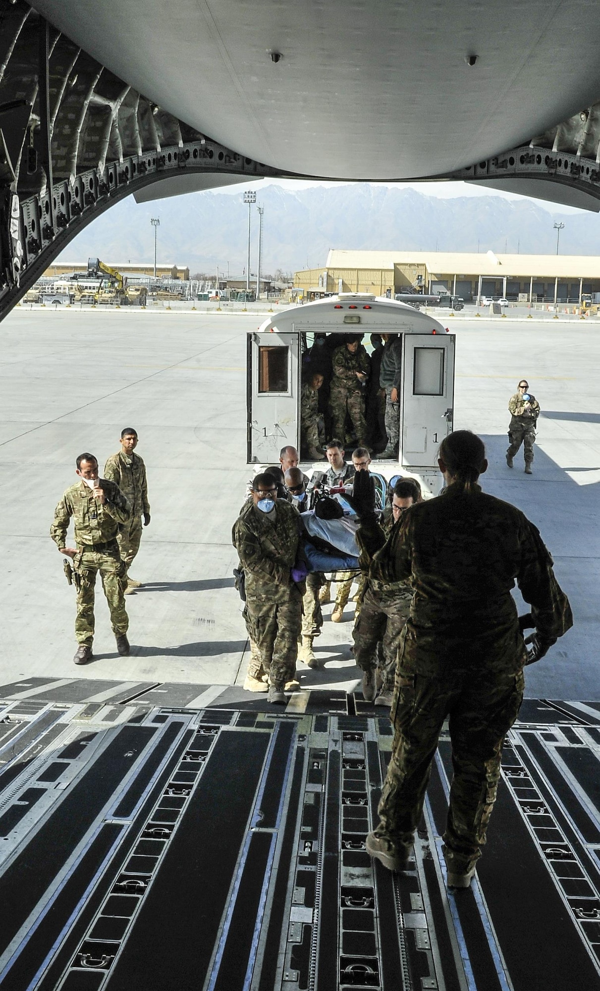 A 455th Expeditionary Medical Group team loads a NATO ally, who required Extracorporeal Membrane Oxygenation team support, onto an aeromedical evacuation transport at Bagram Air Field, Afghanistan, on Feb. 18, 2016. The ECMO team, dispatched from San Antonio Military Medical Center, uses technology that bypasses the lungs and infuses the blood directly with oxygen, while removing the harmful carbon dioxide from the blood stream. The patient was airlifted to Landstuhl Regional Medical Center, Germany, where he will receive 7 to 14 days of additional ECMO treatment. (U.S. Air Force photo by Tech. Sgt. Nicholas Rau)