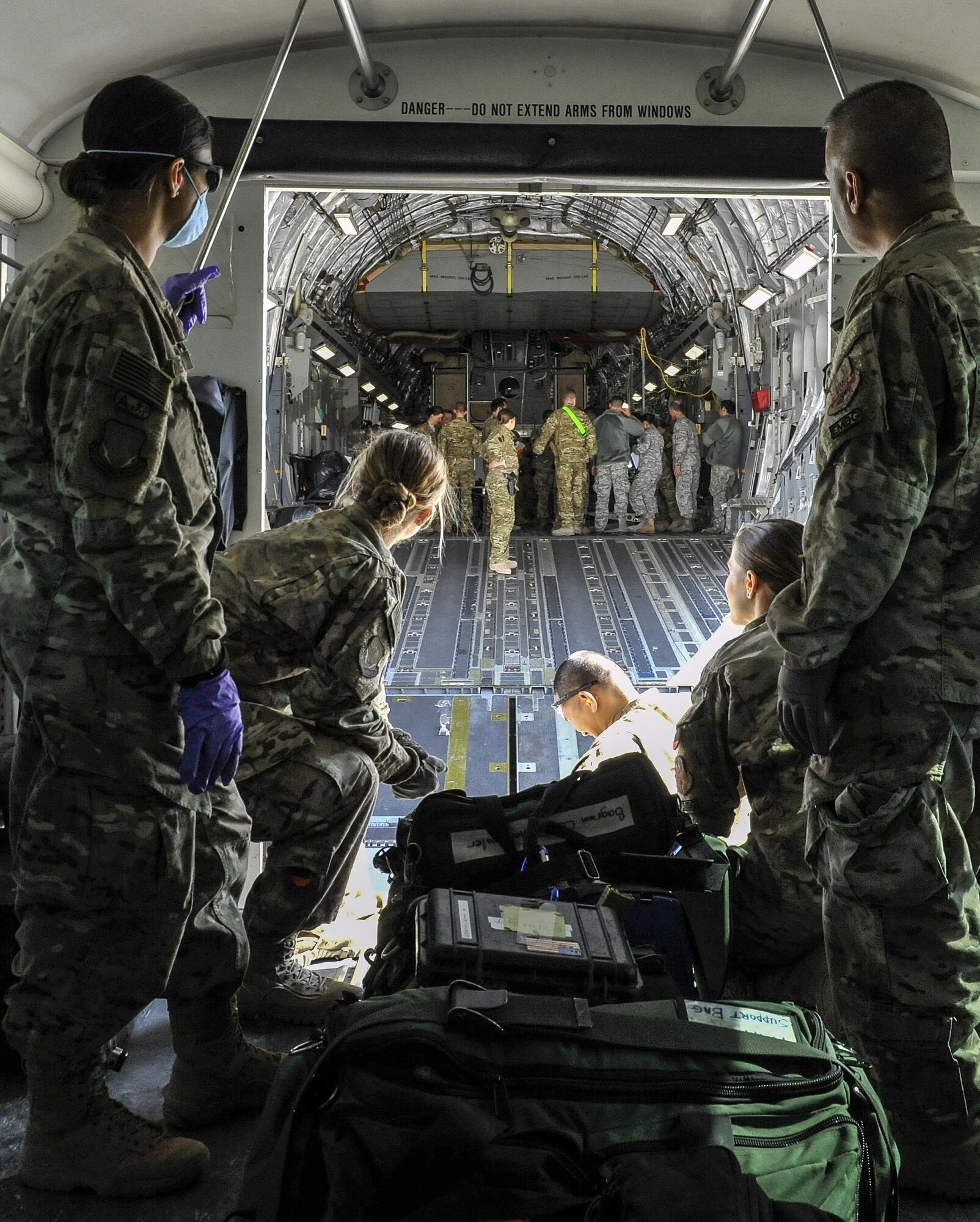 A 455th Expeditionary Medical Group team prepares to load the remaining equipment used to save the life of a NATO ally, who required Extracorporeal Membrane Oxygenation team support, onto an aeromedical evacuation transport at Bagram Air Field, Afghanistan, on Feb. 18, 2016. The ECMO team, dispatched from San Antonio Military Medical Center, uses technology that bypasses the lungs and infuses the blood directly with oxygen, while removing the harmful carbon dioxide from the blood stream. The patient was airlifted to Landstuhl Regional Medical Center, Germany, where he will receive 7 to 14 days of additional ECMO treatment. (U.S. Air Force photo by Tech. Sgt. Nicholas Rau)