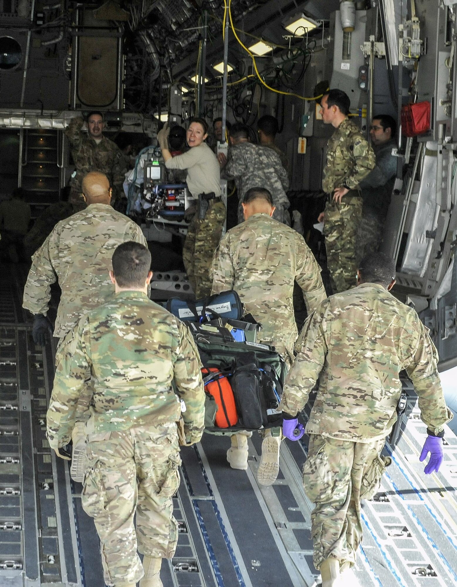 A 455th Expeditionary Medical Group team loads the remaining equipment used to save the life of a NATO ally, who required Extracorporeal Membrane Oxygenation team support, onto an aeromedical evacuation transport at Bagram Air Field, Afghanistan, on Feb. 18, 2016. The ECMO team, dispatched from San Antonio Military Medical Center, uses technology that bypasses the lungs and infuses the blood directly with oxygen, while removing the harmful carbon dioxide from the blood stream. The patient was airlifted to Landstuhl Regional Medical Center, Germany, where he will receive 7 to 14 days of additional ECMO treatment. (U.S. Air Force photo by Tech. Sgt. Nicholas Rau)