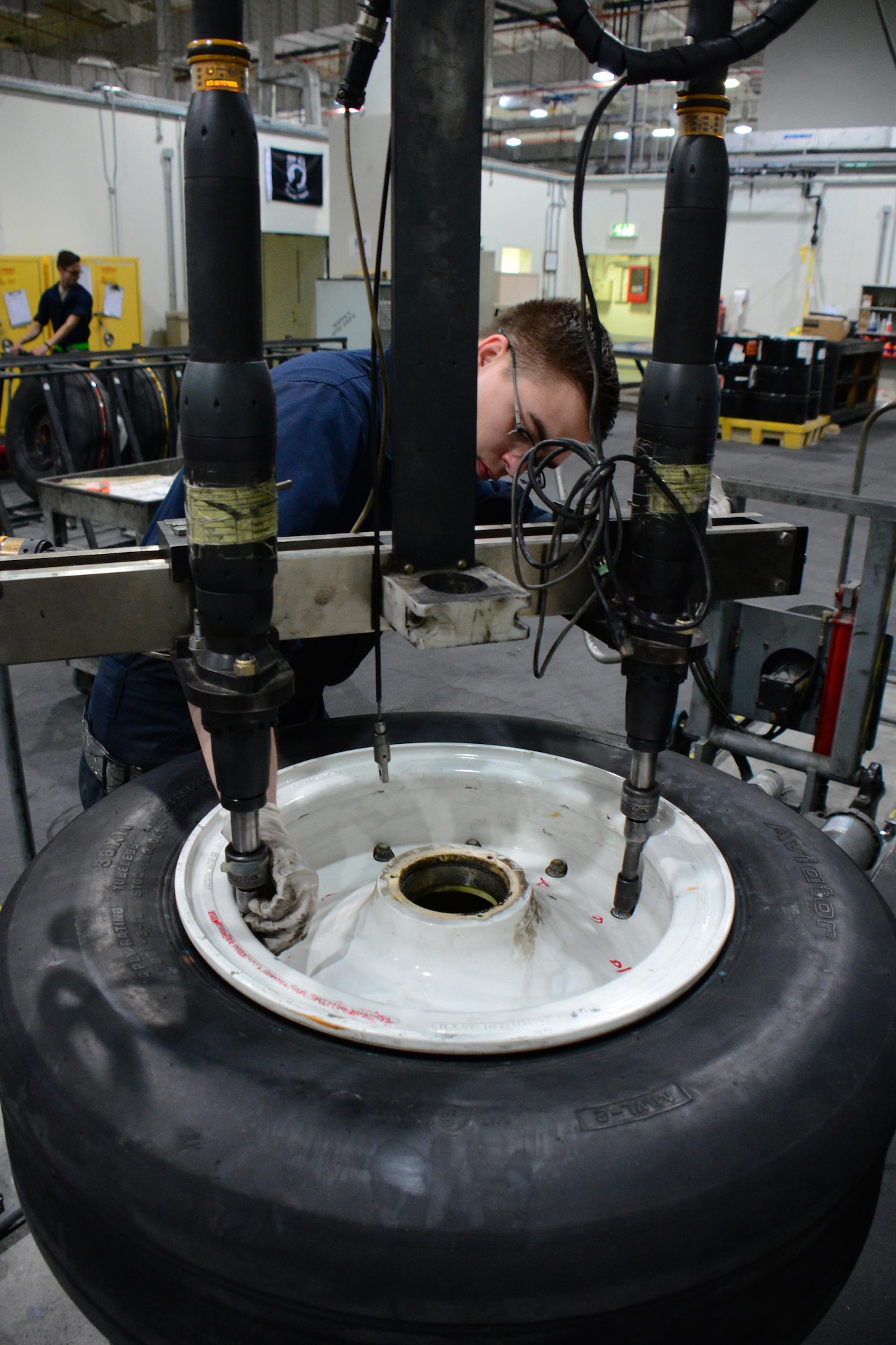 Airman 1st Class Bobbie Price III, 379th Expeditionary Maintenance Squadron aerospace maintenance journeyman, from League City, Texas, uses an automatic torque machine to remove the bolts holding a wheel together at Al Udeid Air Base, Qatar Feb. 16. The machine is programmed to quickly remove the bolts of any U.S. Air Force aircraft at AUAB. (U.S. Air Force photo by Tech. Sgt. James Hodgman/Released)