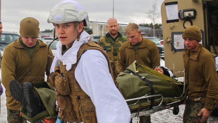 A Norwegian soldier and U.S. Marines with the 2nd Marine Expeditionary Brigade carry a notional casualty toward a medical tent during combat casualty care training in Rena, Norway, Feb. 17, 2016. The countries collaborated in order to enhance one another’s medical capabilities in preparation for Exercise Cold Response 16 in March, which brings together 12 NATO allies and partner nations to enhance joint crisis response capabilities in cold weather settings. 