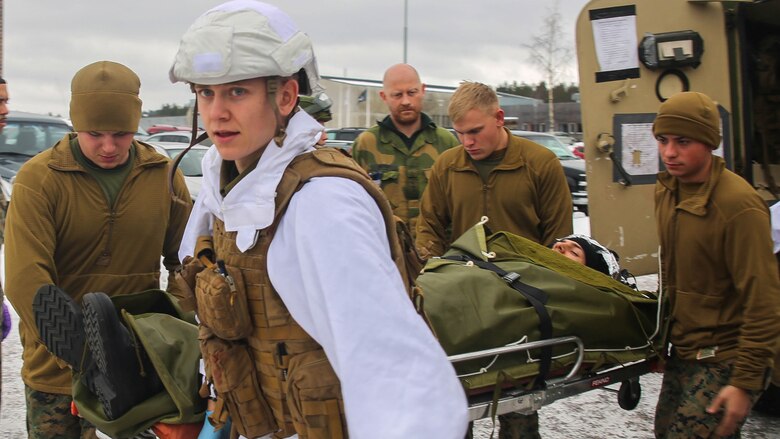 A Norwegian soldier and U.S. Marines with the 2nd Marine Expeditionary Brigade carry a notional casualty toward a medical tent during combat casualty care training in Rena, Norway, Feb. 17, 2016. The countries collaborated in order to enhance one another’s medical capabilities in preparation for Exercise Cold Response 16 in March, which brings together 12 NATO allies and partner nations to enhance joint crisis response capabilities in cold weather settings. 