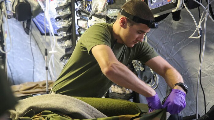 Hospital man 1st Class Matthew Malone, a corpsman with the 2nd Marine Expeditionary Brigade, cuts open the trousers of a simulated Norwegian soldier casualty during combat casualty care training in Rena, Norway, Feb. 17, 2016. About ten Marines and sailors from the unit make up the shock trauma squad, and had the opportunity to conduct notional medical procedures on the Norwegians while also using some of the host nation’s medical equipment. The U.S. will collaborate with the Norwegians and 10 other NATO allies and partner nations for Exercise Cold Response 16 in March, which is designed to enhance joint crisis response capabilities in cold weather environments.