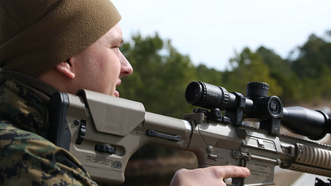 Lance Cpl. Hunter Landrum, a military policeman with Bravo Company, 2nd Law Enforcement Battalion, readies his rifle as a simulated fight starts to escalate during an interior guard training exercise at Forward Observation Base Hawk at Marine Corps Base Camp Lejeune, N.C., Feb. 17, 2016. The training prepared Marines to conduct real-life site security operations. 