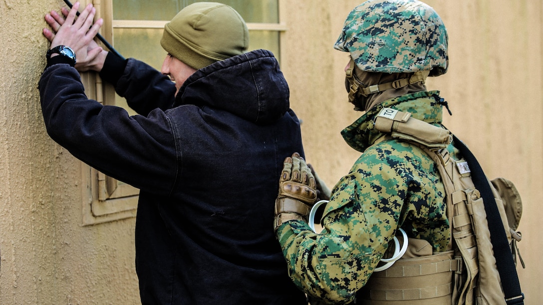 Marines with Bravo Company, 2nd Law Enforcement Battalion, simulate a security check at an entry control point of a forward observation during an interior guard training exercise at Forward Observation Base Hawk at Marine Corps Base Camp Lejeune, N.C., Feb. 17, 2016. The training prepared Marines to conduct real-life site security operations. 