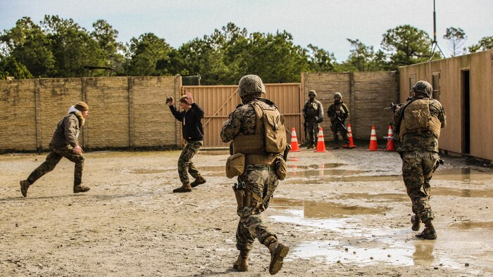 Marines with Bravo Company, 2nd Law Enforcement Battalion, simulate civilians in physical altercations at a forward observation base, which requires Marines to step in and take control of the situation during an interior guard training exercise at Forward Observation Base Hawk at  Marine Corps Base Camp Lejeune, N.C., Feb. 17, 2016. The training prepared Marines to conduct real-life site security operations. 