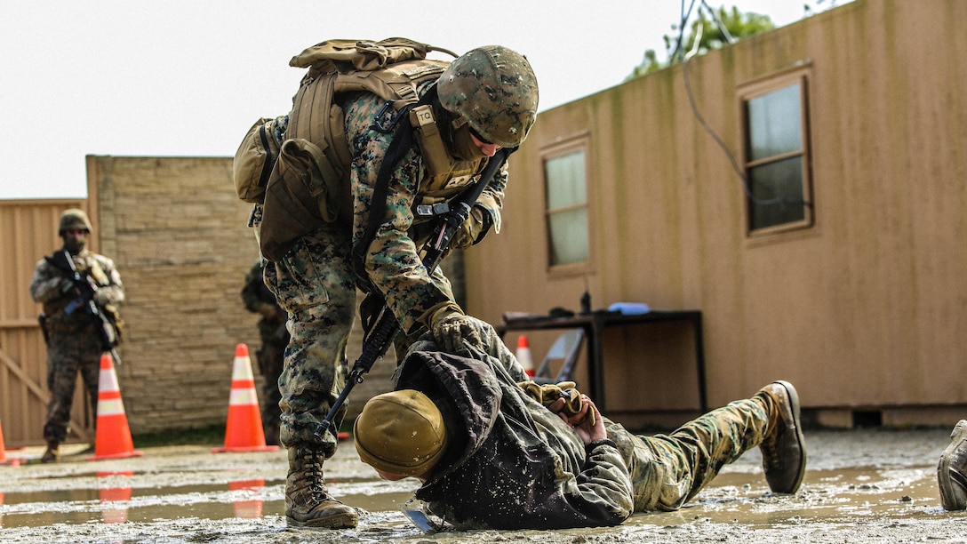 Marines with Bravo Company, 2nd Law Enforcement Battalion, subdue role players after a notional altercations at a forward observation base during an interior guard training exercise at Forward Observation Base Hawk at Marine Corps Base Camp Lejeune, N.C., Feb. 17, 2016. The training prepared Marines to conduct real-life site security operations. 