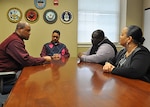 Defense Logistics Agency Aviation Command Support Directorate's Internal Review Office employees discuss internal and external controls and how to ensure all established guidelines and procedures are implemented and followed. Shown are: Internal Review Evaluators Robert Williams, left; Angel Quinones,center; Internal Review Management Analyst Orlando Allen; and Internal Review Evaluator Dana Booker. 