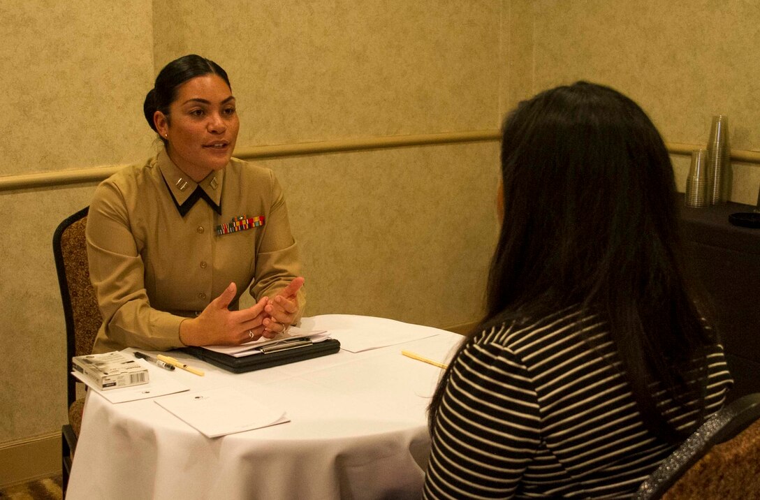 Captain Evita Mosqueda-Chapman speaks to a student about different career opportunities available in the Marine Corps during the Mexican American Engineers and Scientists career fair in San Antonio, February 18, 2016. Partnering with Latino organizations like MAES provides the Marine Corps with the ability  to build relationships with influential community leaders who become brand ambassadors for the Marine Corps. Mosqueda-Chapman currently serves as the assistant logistics officer with 4th tank battalion, 4th Marine Division.