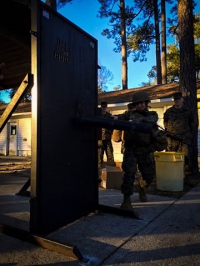 On January 11, 2016 Second Lieutenant Eric Henegar, a Marine attached to Combat Engineer Officer course 3-16 (CEO 3-16) at Marine Corps Engineer School Camp Lejeune, N.C.; conducts a door breach during the  Military Occupational Specialty Specific Physical Standards test (MSPS). 
