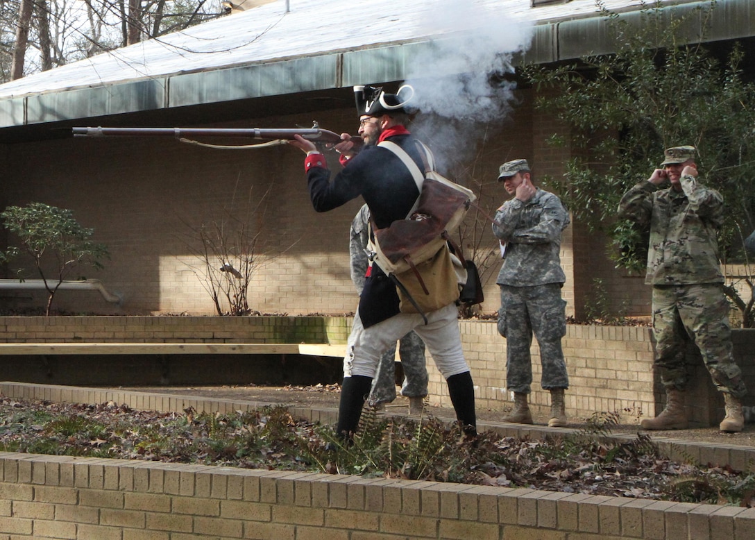 Dressed in a period correct Continental uniform, Guilford Courthouse National Park ranger Jason Baum fires a rifle similar to those Continental soldiers would have employed against the British Army during the Revolutionary War. The demonstration was part of a staff ride conducted by the 108th Training Command (IET) at the Greensboro, N.C., park on Feb. 6. The staff rides are training events used by staff members of the unit to learn important lessons from the past in order to ensure success in future conflicts. (U.S. Army photo by Sgt. Javier Amador)
