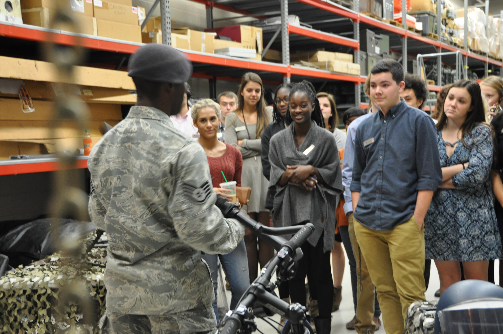 Staff Sgt. Marcus Walker shares some equipment used by the 94th Security Forces with Cobb Youth Leadership students. The high school students visited Dobbins on December 7, 2015 to learn some of the roles and responsibilities of Airmen. (U.S. Air Force photo by Senior Airman Lauren Douglas)