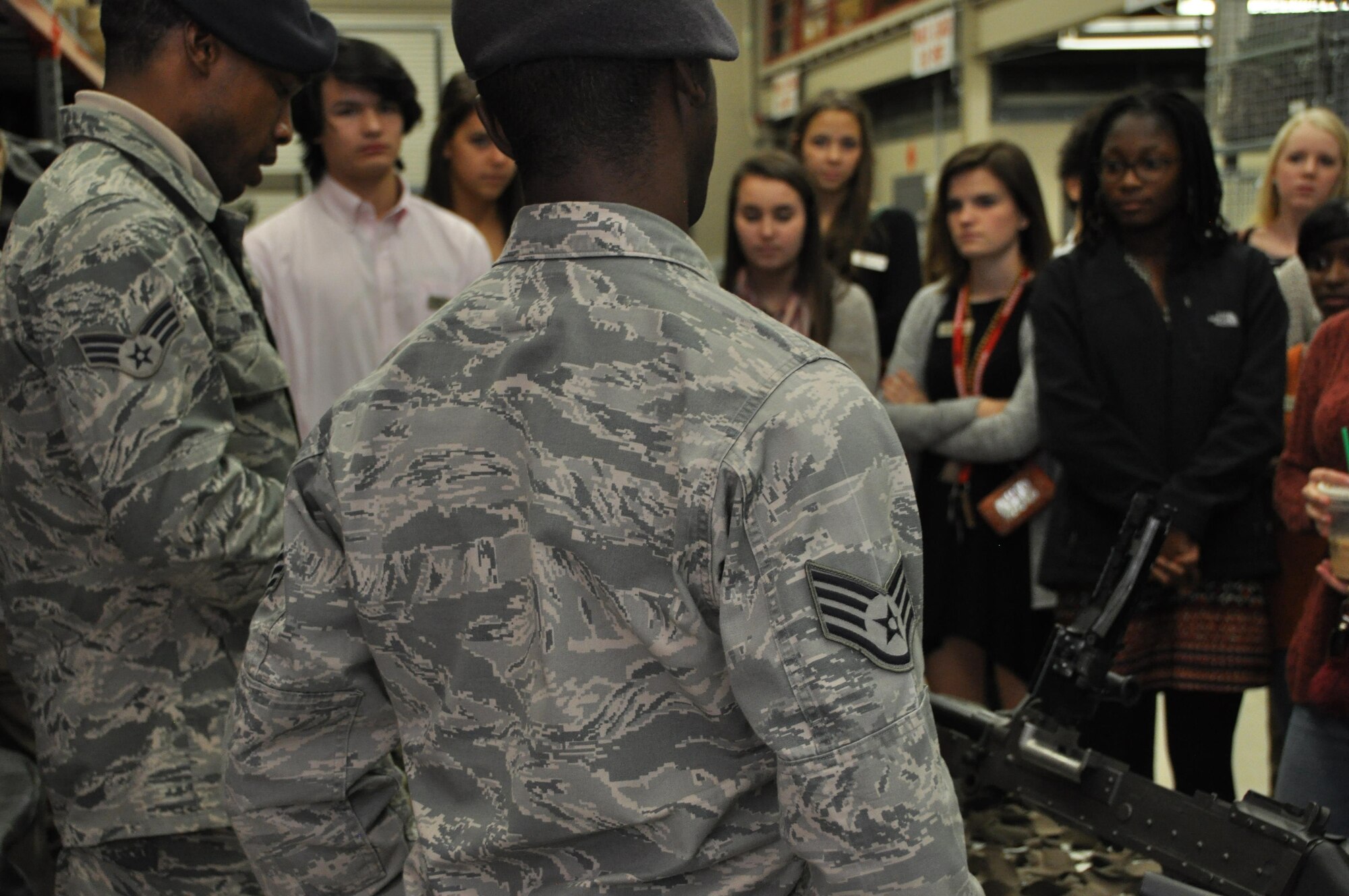 Staff Sgt. Marcus Walker and Senior Airman Gerald Jordan speak to Cobb Youth Leadership students about weapons and other equipment they have on display. Students actively participated and asked questions during the presentation. (U.S. Air Force photo by Senior Airman Lauren Douglas)
