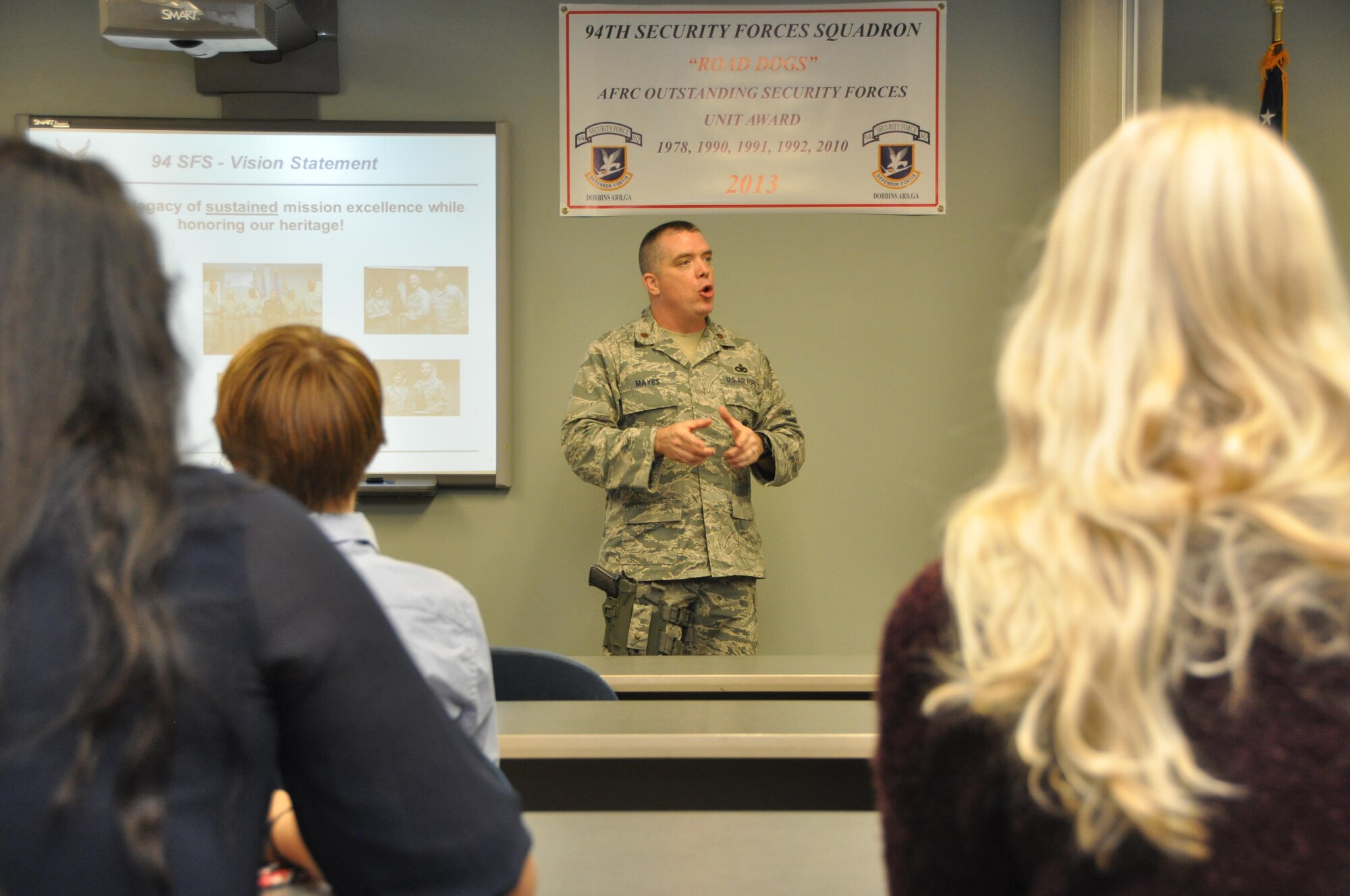 Students from Cobb Youth Leadership program are briefed by Maj. Robert Mayes about the 94 Security Forces mission. CYL is a program for Cobb County high school students to receive an interactive experience of the surrounding community. 
