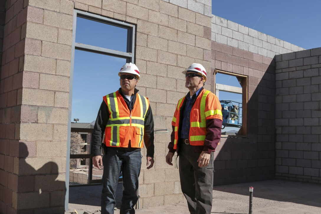 Rich Fontanilla (left), the Area Engineer for the U.S. Army Corps of Engineers Los Angeles District's Arizona-Nevada Area Office, and Pete Pupparo, resident engineer for the District's Las Vegas Resident Office, visit a 240-room dormitory project at Nellis Air Force Base Feb. 11. The $30.4 million H-shaped complex features 60 quads; each with a four-bedroom and four-bathroom unit, a shared kitchen, laundry and dining area.