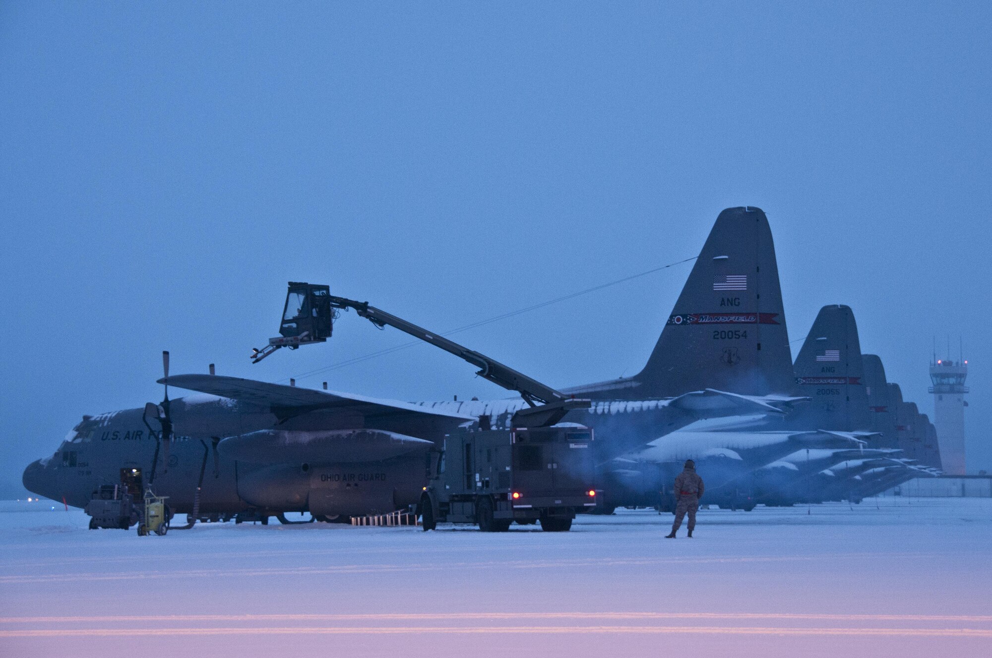 Ohio Air National Guard members work in the early morning of Feb. 16, 2016, to remove snow from the flightline and fleet of C-130H Hercules at the 179th Airlift Wing, Mansfield, Ohio. The Ohio ANG unit is always on mission to respond with highly qualified citizen Airmen to execute federal, state and community missions. (U.S. Air National Guard photo/Tech. Sgt. Joe Harwood)