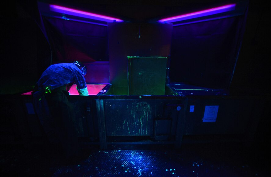 Staff Sgt. Joel Kelehar, a 100th Maintenance Squadron non-destructive inspection craftsman, dips a KC-135 Stratotanker accumulator into a hydrophilic remover Feb. 3, 2016, on Royal Air Force Mildenhall, England. The bath removes any excess penetrant that a simple rinse of water is not able to do. (U.S. Air Force photo/Senior Airman Christine Halan)