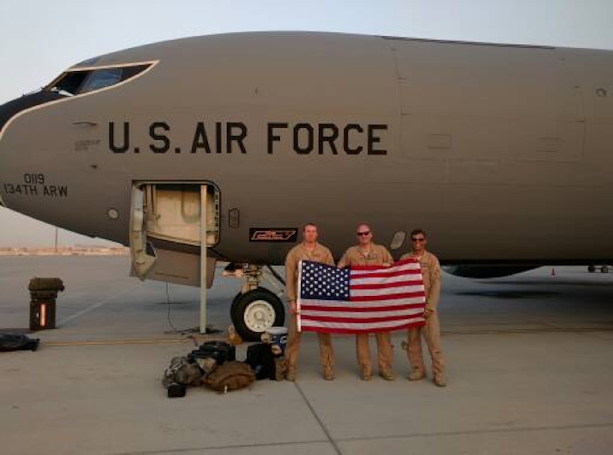 Senior Airman Jonathan Nigl, left, a 384th Air Refueling Squadron boom operator, Maj. Robert Bradley and Capt. Nathanial Beer, both 384th ARS pilots, pose for a photo in front of their aircraft. (Courtesy photo)