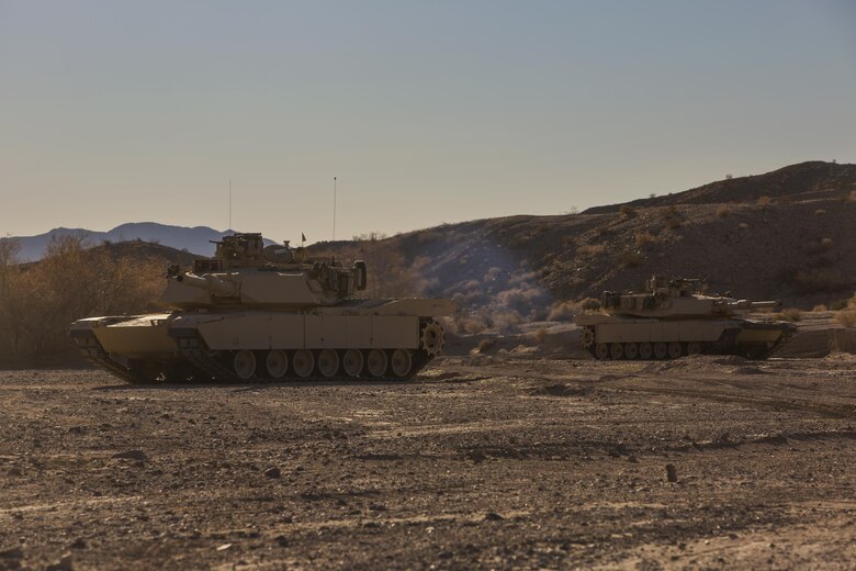 Two M1A1 Abrams Main Battle Tanks with Company A, 1st Tank Battalion,  post security along a road during a Tank Mechanized Assault Course as part of Integrated Training Exercise 2-16 in the Quackenbush Training Area aboard the Combat Center Feb. 9, 2016. ITX is designed to prepare units for combat, under the most realistic conditions possible, focusing on battalion and squad level training. (Official Marine Corps photo by Lance Cpl. Levi Schultz/Released)