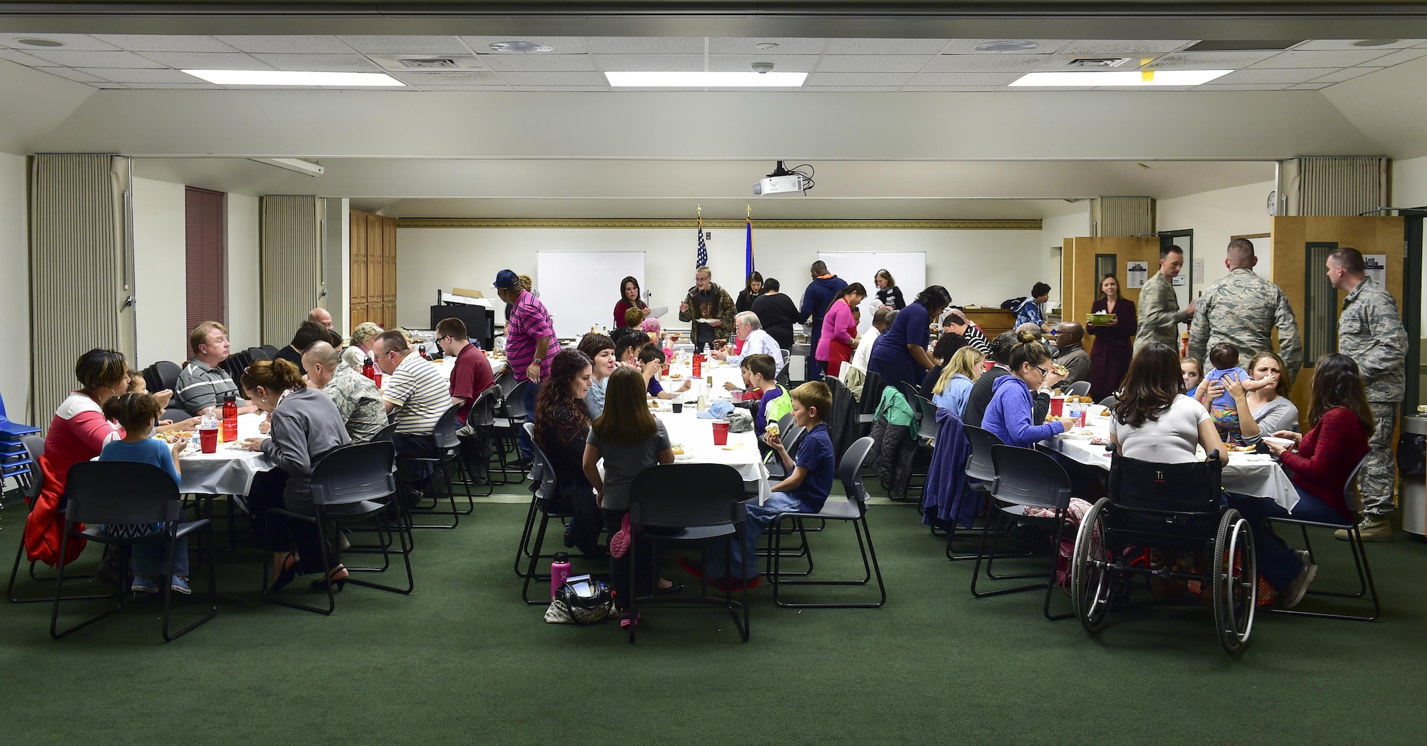 Families receive a free dinner during a deployed families’ dinner at the chapel, Hurlburt Field, Fla., Feb. 11, 2016. The deployed families’ dinner offers an environment for spouses to share knowledge, advice and support while their loved ones are deployed. (U.S. Air Force photo by Senior Airman Jeff Parkinson)