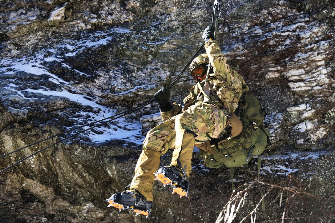 A soldier rappels down the face of a cliff on Smugglers’ Notch in Jeffersonville, Vt., Feb. 18, 2016. The soldier, assigned to the Vermont National Guard, was participating in an event for basic and advanced mountain warfare students of the Mountain Warfare School. Vermont National Guard photo by Army Staff Sgt. Nathan Rivard
