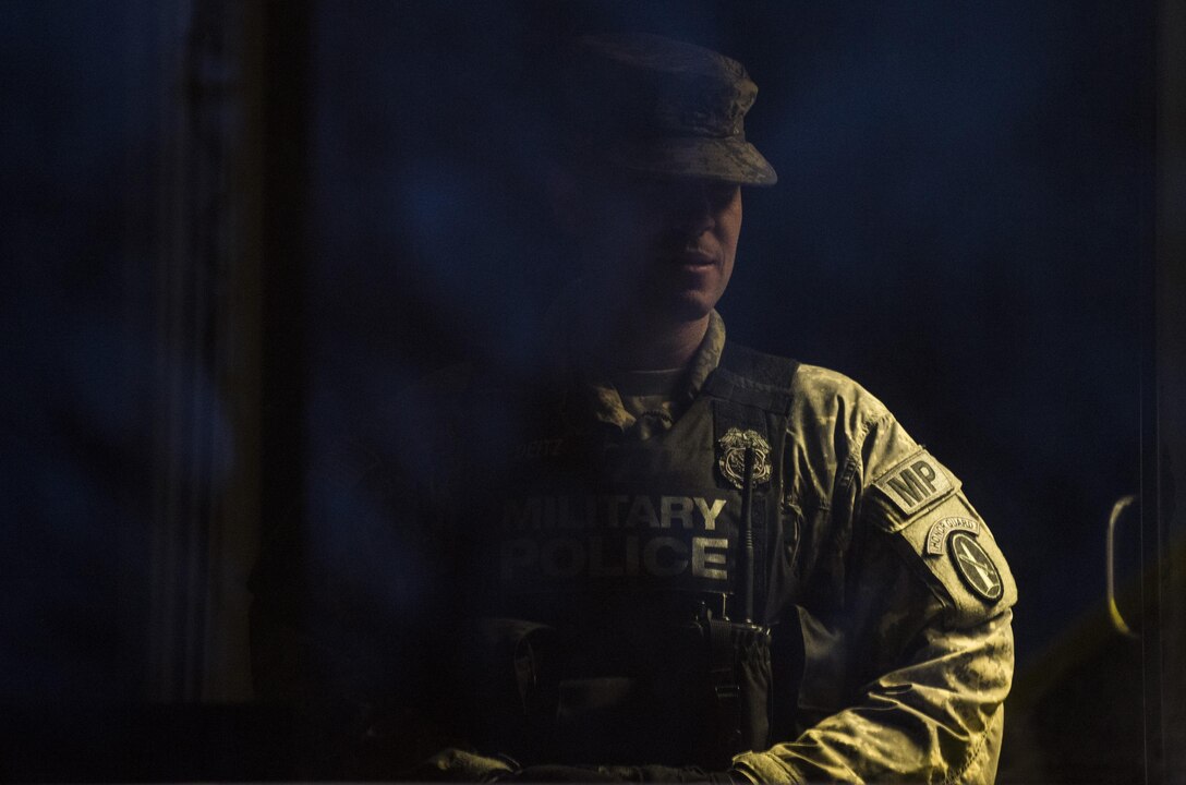 Staff Sgt. Micheal Deitz, patrol supervisor for the 289th Military Police Company, belonging to the 3rd U.S. Infantry Regiment (The Old Guard), watches as a U.S. Army Reserve Soldier conducts guard duty in the Military District of Washington, D.C., Feb. 17. This partnership is part of a pilot program that began in early February, placing Army Reserve MP Soldiers on active duty orders for three weeks while working at Joint Base Myer-Henderson Hall, Fort Lesley J. McNair and the Arlington National Cemetery. Soldiers will also support the Military District of Washington with additional duty days throughout the year. (U.S. Army photo by Master Sgt. Michel Sauret)