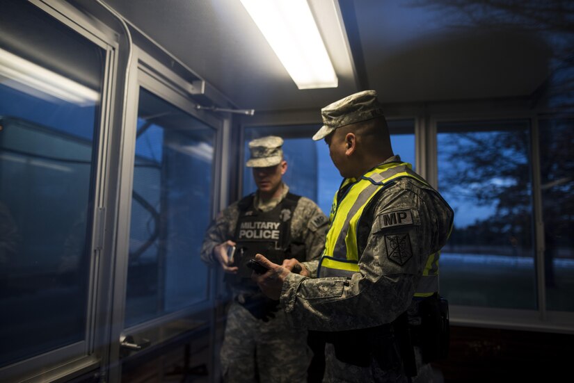 Sgt. Michael Villena (right), U.S. Army Reserve military police Soldier from Manassas Park, Va., with the 352nd MP Company, of the 200th MP Command, talks with Staff Sgt. Micheal Deitz, patrol supervisor for the 289th MP Co., belonging to the 3rd U.S. Infantry Regiment (The Old Guard), during a partnership program giving Army Reserve Soldiers the opportunity to provide law and order, security and patrol support at various active duty installations in the Military District of Washington, D.C., Feb. 17. This partnership pilot program began in early February, placing Army Reserve Soldiers on active duty orders for three weeks while working at Joint Base Myer-Henderson Hall, Fort Lesley J. McNair and the Arlington National Cemetery. Soldiers will also support the Military District of Washington with additional duty days throughout the year. (U.S. Army photo by Master Sgt. Michel Sauret)