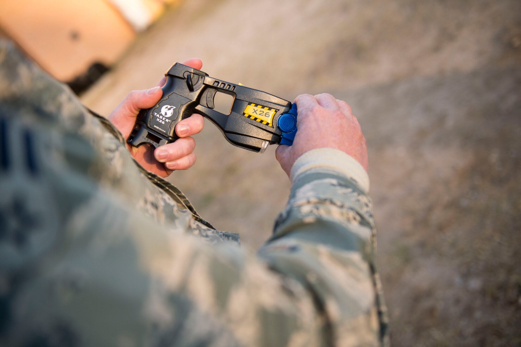 An Airman with the 1st Special Operations Security Forces Squadron loads a taser gun with a training cartridge during taser training at Hurlburt Field, Fla., Feb. 10, 2016.  If a suspect isn’t complying with verbal orders, the use of a taser on a suspect can be a secondary use of force. (U.S. Air Force photo by Senior Airman Krystal M. Garrett)