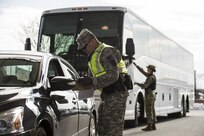 Sgt. Michael Villena (right), U.S. Army Reserve military police Soldier from Manassas Par, Va., with the 352nd MP Company, of the 200th MP Command, checks a driver's paperwork at one of the entry gates to Joint Base Myer-Henderson Hall, as part of a partnership training program with active duty Soldiers from the 289th MP Co., belonging to the 3rd U.S. Infantry Regiment (The Old Guard), to provide law and order, security and patrol support at various active duty installations in the Military District of Washington, D.C., Feb. 17. This partnership pilot program began in early February, placing Army Reserve Soldiers on active duty orders for three weeks while working at Joint Base Myer-Henderson Hall, Fort Lesley J. McNair and the Arlington National Cemetery. Soldiers will also support the Military District of Washington with additional duty days throughout the year. (U.S. Army photo by Master Sgt. Michel Sauret)