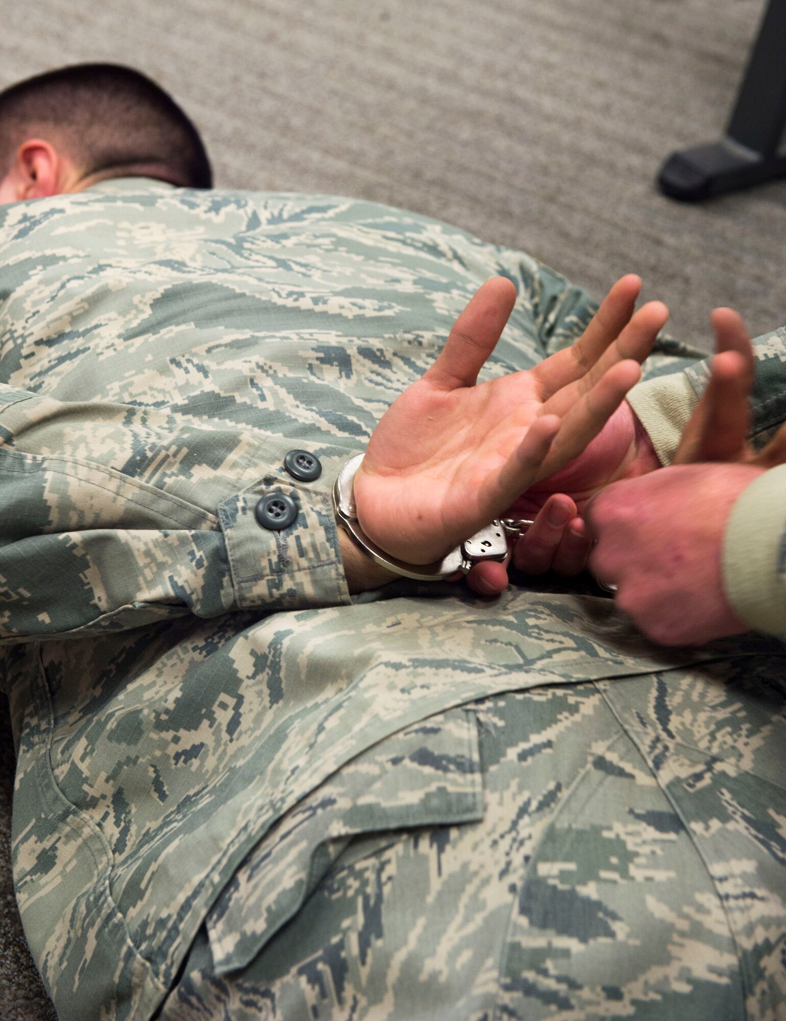 Airmen with the 1st Special Operations Security Forces Squadron practice apprehending suspects during handcuff and search training at the 1st SOSFS, Hurlburt Field, Fla., Feb. 10, 2016. Security Forces personnel must ensure they thoroughly follow the steps taught in training when checking suspects before placing them in handcuffs. (U.S. Air Force photo by Senior Airman Krystal M. Garrett)