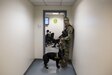Pfc. Michael Fletcher, military police Soldier with the 289th MP Company, waits outside of a morning meeting with Cessy, a military K9 police dog, at Joint Base Myer-Henderson Hall, Va., Feb. 17. The 289th MP Co., belonging to the 3rd U.S. Infantry Regiment (The Old Guard), is currently running a partnership pilot program with the U.S. Army Reserve's 200th MP Command, which began in early February, placing Army Reserve Soldiers on active duty orders for three weeks while working at Joint Base Myer-Henderson Hall, Fort Lesley J. McNair and the Arlington National Cemetery. Army Reserve Soldiers will also support the Military District of Washington with additional duty days throughout the year. (U.S. Army photo by Master Sgt. Michel Sauret)