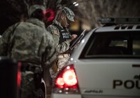 Sgt. Jacob Conrad (right), active duty military police Soldier with the 289th MP Company, belonging to the 3rd U.S. Infantry Regiment (The Old Guard), conducts his early-morning vehicle inspection before going on patrol along with U.S. Army Reserve Soldiers from the 200th MP Command in the Military District of Washington, D.C., Feb. 17. Their joint partnership is part of a pilot program that began in early February, placing Army Reserve Soldiers on active duty orders for three weeks while working at Joint Base Myer-Henderson Hall, Fort Lesley J. McNair and the Arlington National Cemetery. Army Reserve Soldiers will also support the Military District of Washington with additional duty days throughout the year. (U.S. Army photo by Master Sgt. Michel Sauret)