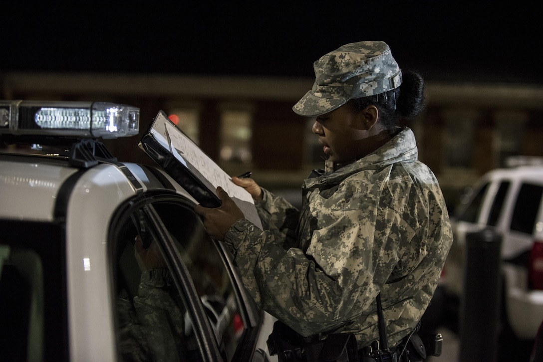 Pvt. Kaloni Alston, U.S. Army Reserve military police Soldier from Temple Hills, Md., with the 443rd MP Company, of the 200th MP Command, conducts a vehicle inspection on her assigned police car during a morning patrol with active duty Soldiers from the 289th MP Co., belonging to the 3rd U.S. Infantry Regiment (The Old Guard), in the Military District of Washington, D.C., Feb. 17. This partnership pilot program began in early February, placing Army Reserve Soldiers on active duty orders for three weeks while working at Joint Base Myer-Henderson Hall, Fort Lesley J. McNair and the Arlington National Cemetery. Soldiers will also support the Military District of Washington with additional duty days throughout the year. (U.S. Army photo by Master Sgt. Michel Sauret)