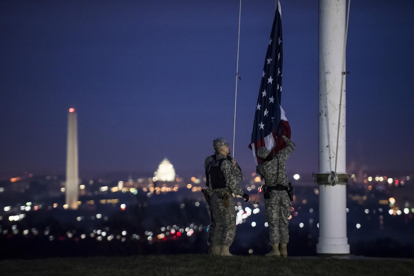 Pvt. Kaloni Alston (right), U.S. Army Reserve military police Soldier from Temple Hills, Md., with the 443rd MP Company, of the 200th MP Command, helps raise the American flag during a morning detail along with two active duty Soldiers from the 289th MP Co., belonging to the 3rd U.S. Infantry Regiment (The Old Guard), during a working partnership in the Military District of Washington, D.C., Feb. 17. This partnership pilot program began in early February, placing Army Reserve Soldiers on active duty orders for three weeks while working at Joint Base Myer-Henderson Hall, Fort Lesley J. McNair and the Arlington National Cemetery. Soldiers will also support the Military District of Washington with additional duty days throughout the year. (U.S. Army photo by Master Sgt. Michel Sauret)
