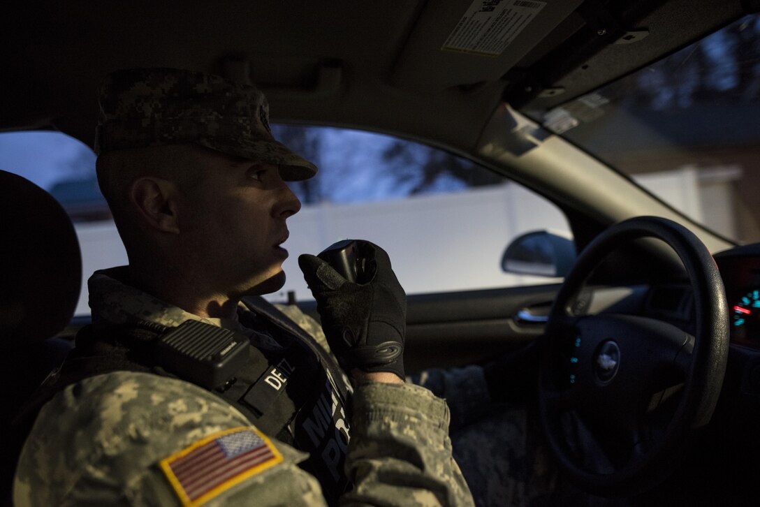 Staff Sgt. Micheal Deitz, patrol supervisor for the 289th Military Police Company, belonging to the 3rd U.S. Infantry Regiment (The Old Guard), calls in his location over the radio while on patrol in the Military District of Washington, D.C., Feb. 17. The 289th MP Co. is currently operating a partnership with U.S. Army Reserve MP Soldiers from the 200th MP Command as part of a pilot program that began in early February, placing Army Reserve MPs on active duty orders for three weeks while working at Joint Base Myer-Henderson Hall, Fort Lesley J. McNair and the Arlington National Cemetery. Soldiers will also support the Military District of Washington with additional duty days throughout the year. (U.S. Army photo by Master Sgt. Michel Sauret)