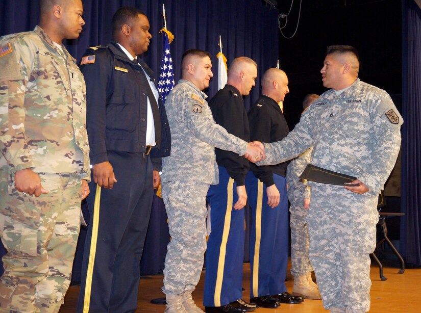U.S. Army Lt. Col. Macedonio R. Molina, director of Emergency Services and provost marshal for Joint Base Myer-Henderson Hall, center left, shakes hands with the newest U.S. Army Reserve military police from the 200th MP Command of Fort Meade, Md., on Feb. 10 at Joe Rosenthal Theater on the Henderson Hall portion of the joint base. Members of the 200th MP Command, following a two-week law enforcement training course, will boost JBM-HH’s law enforcement manpower and force protection posture for the first time since Sept. 11, 2001, according to JBM-HH Police Chief William Johnson (second from left). (Joint Base Myer-Henderson Hall PAO photo by Arthur Mondale)
