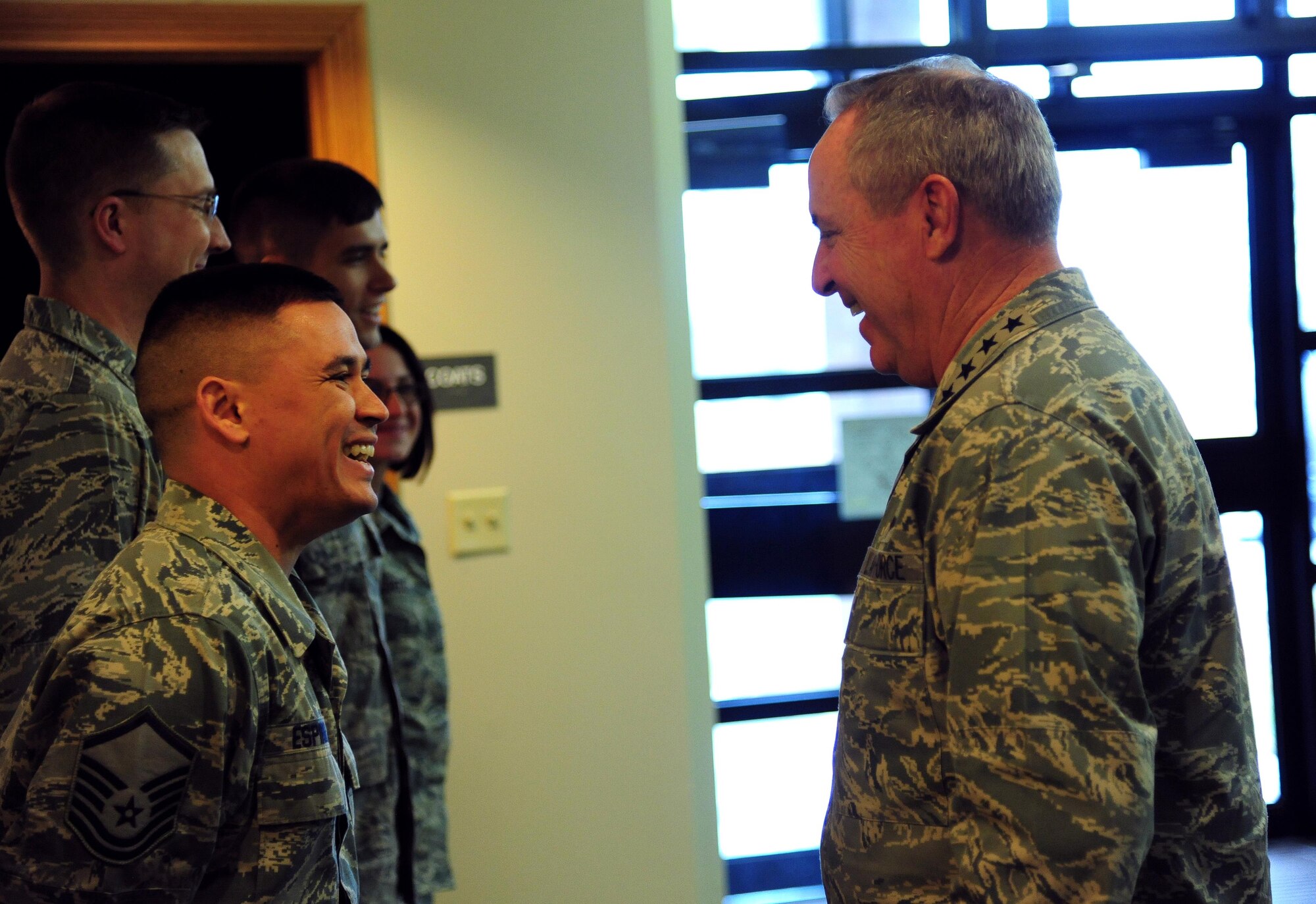 U.S. Air Force Master Sgt. Christopher Espinosa, a member of the 509th Medical Operations Squadron, shares a laugh with Air Force Chief of Staff Gen. Mark A. Welsh III at Whiteman Air Force, Mo., Feb. 16, 2016. Welsh met with Airmen and civic leaders during a base tour and held an all call where he expressed his gratitude to the Total Force Airmen and their support of the unique B-2 mission at Whiteman. (U.S. Air Force photo by Senior Airman Joel Pfiester)