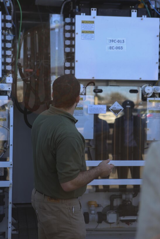 Mick Wasco, energy program manager for Marine Corps Air Station Miramar, Calif., explains to a Korean delegation the uses of a Primus Power battery during their visit aboard MCAS Miramar, Feb. 17. A Primus Power battery is a liquid battery used for energy storage on the electric grid aboard the installation. The delegation consisted of 14 South Korean and two American citizens. (U.S. Marine Corps photo by Cpl. Kimberlyn Adams/Released)